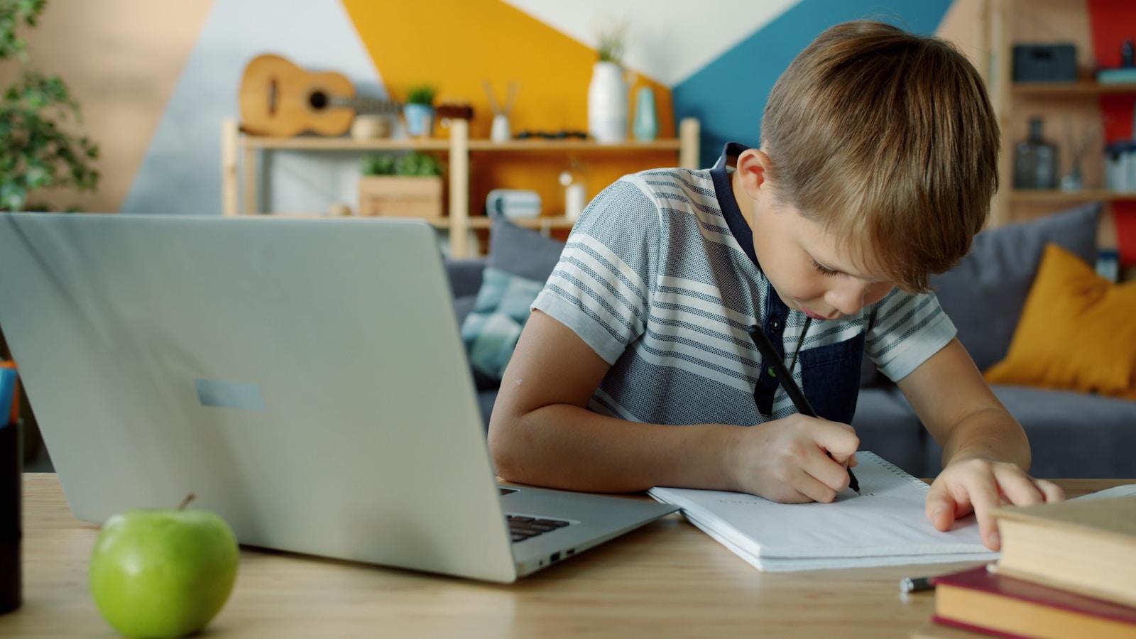 Student learning with laptop and notebook